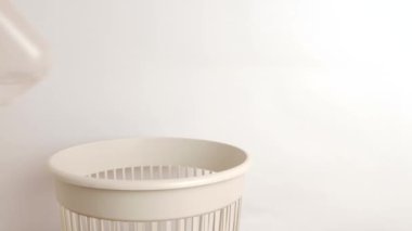 Plastik bir şişe sıvı çöp sahasına atılıyor. Çöp öğütme ve geri dönüşüm için.