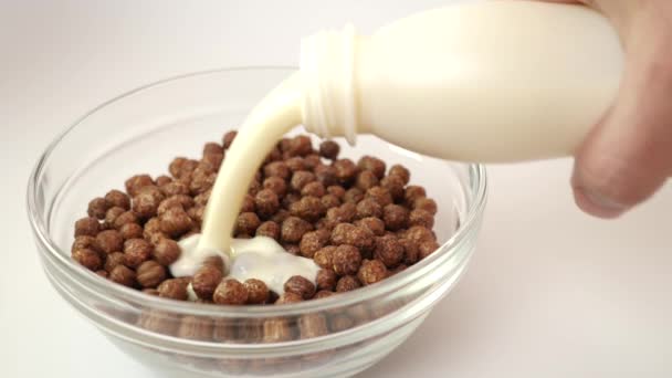 Yogurt Dituangkan Dalam Mangkuk Granola Transparan Dengan Latar Belakang Putih — Stok Video