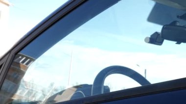 The man washes the car windows with detergent and a rag. Car cleaning concept.