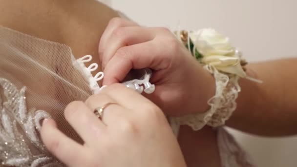 Friend Helps Bride Wear Wedding Dress Buttoning Back — Stock Video