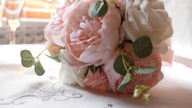Beautiful bouquet of artificial, plastic flowers lying on the table.