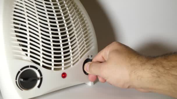 Person Turns Fan Heater Heat Room Portable Autonomous Electric Space — Stockvideo