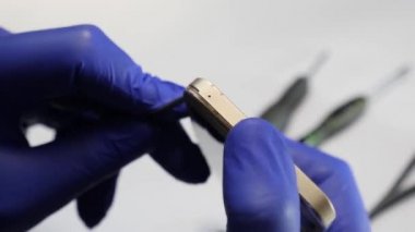 Mobile phone repair. Digital gadget service. The process of dismantling the phone.
