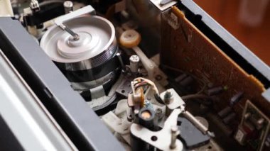 The work of the mechanics of the tape long mechanism. Rewinding the VHS tape