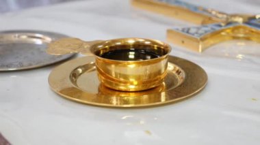Golden bowl with wine for a church ceremony. Items of church worship and national rites.