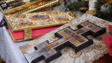 Church items. The cross with the crucifix and the precious Gospel. Church wedding ceremony of brides.