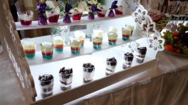Festive sweet table with fruits, sweets and cakes. Harmonious serving of a sweet table. Buffet table.
