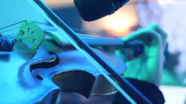 Musician Playing Violin Lit Stage Lights Dancing People Background — Stock video