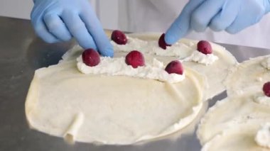 Preparation of pancakes with cheese and cherries. Homemade dishes. European cuisine