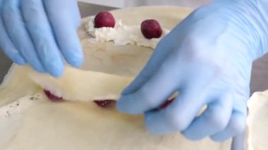 Preparation of pancakes with cheese and cherries. Homemade dishes. European cuisine