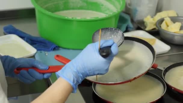 Frying Pancake Batter Work Four Pans Same Time — стоковое видео