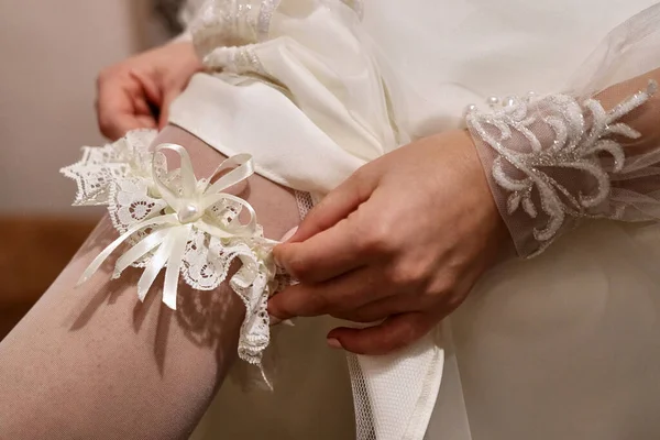 Невеста Свадебным Платьем Надевает Подвязку — стоковое фото