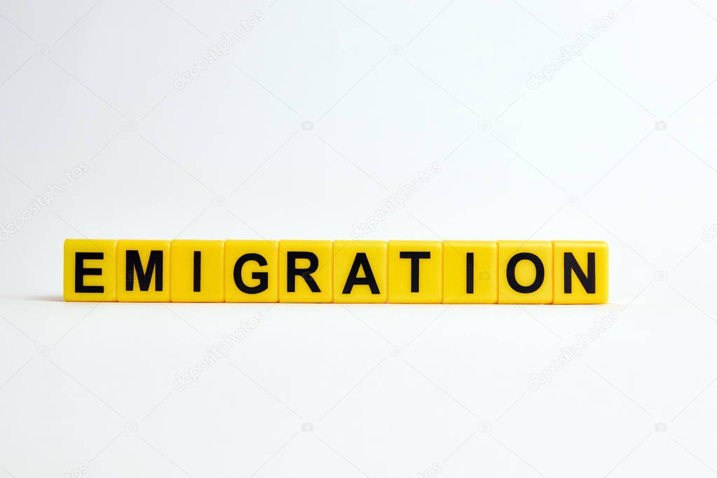 imigration text  made from  yellow plastic blocks on a white background
