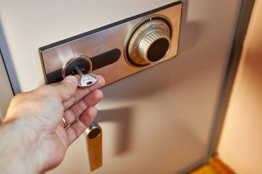 close-up of a hand opening safe 