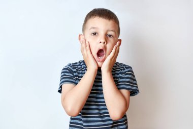 Küçük çocuk ellerini büyüleyici bir şekilde yanaklarına aldı, ağzını ardına kadar açtı..