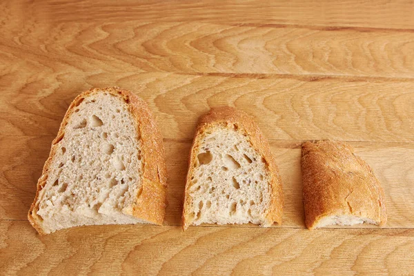 Three Pieces Bread Bigger Smaller Even Smaller Wooden Board Food — Stockfoto