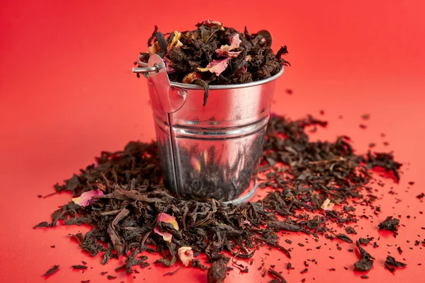 Paper packaging with fruit tea on a red background.