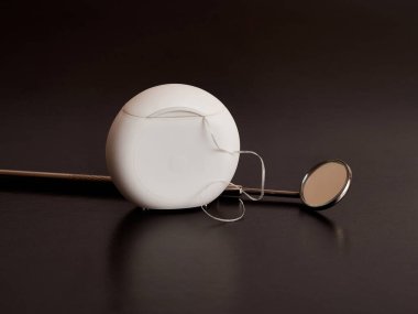 Dental mirror and dental floss on a black background. Dental care.