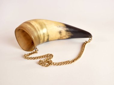 Cow horn trimmed and decorated in the form of beauty on a white background.