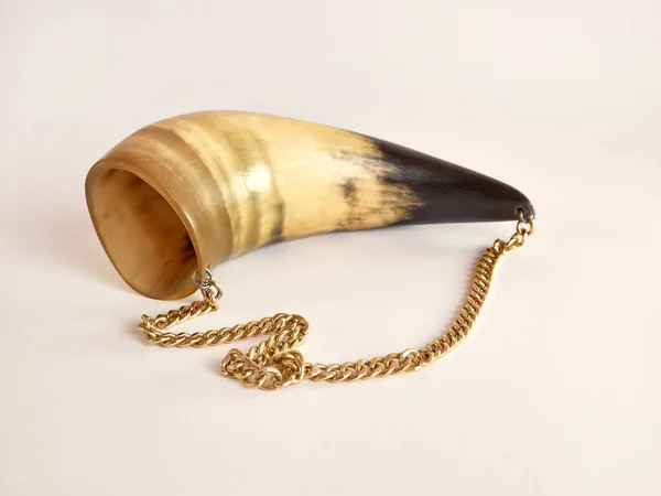 Cow horn trimmed and decorated in the form of beauty on a white background.