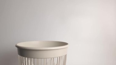 Plastic cups are thrown into the trash for disposal and recycling