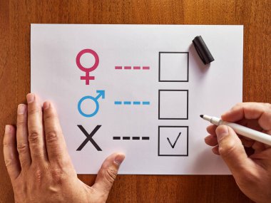 A person is determined by his gender. Sheet of paper with gender symbols. The right to one's identity.