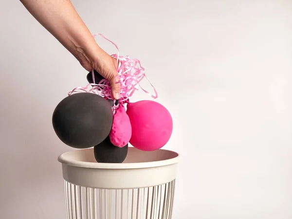 Deflated balloons are thrown into the trash for disposal and recycling