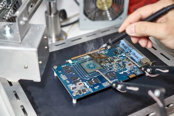 When repairing the motherboard, the chip is unsoldered. Repair and maintenance of computers.