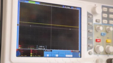 Testing computer equipment using an oscilloscope. Maintenance and repair of computers. Oscilloscope in operation.