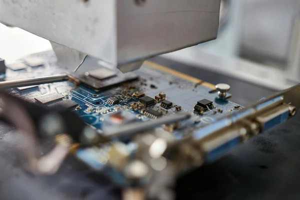 When repairing the motherboard, the chip is unsoldered. Repair and maintenance of computers.