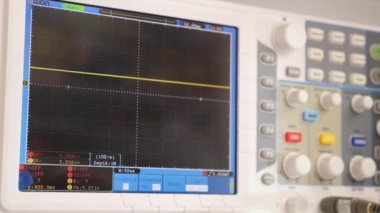 Testing computer equipment using an oscilloscope. Maintenance and repair of computers. Oscilloscope in operation.