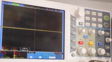 Testing computer equipment using an oscilloscope. Maintenance and repair of computers. Oscilloscope in operation.