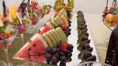 Fruit table. Grapes, pineapples, oranges, tangerines, etc. Buffet table design.