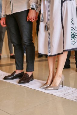 During the wedding ceremony, the bride and groom stand on an embroidered rusheik.