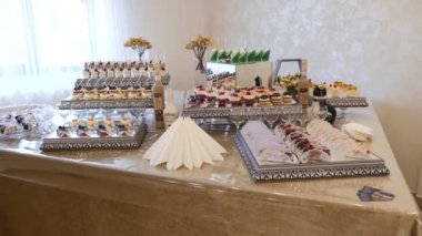 Sweet, buffet table with cakes, pies, cookies with glaze.