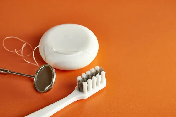Dental Mirror Dental Floss Toothbrush Orange Background Dental Care — Stock Photo, Image