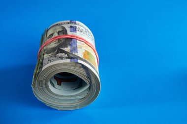 Yüzlerce dolarlık banknotların üzerinde kırmızı bir lastik bant vardı..