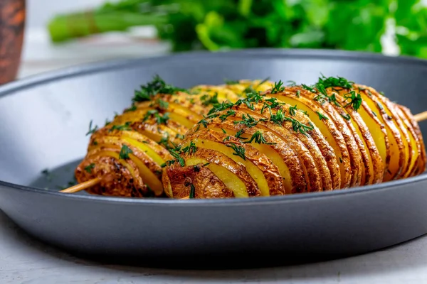 Baked potatoes with herbs on a baking sheet