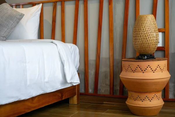 Bamboo Bed Lamp on Ceramic Bed Side Table next to a Bed with Woo