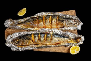 Folyoda limon dilimleri olan iki fırında uskumru.