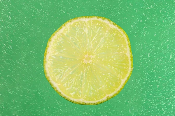 Fresh Lime Slice Wet Green Background — Stockfoto
