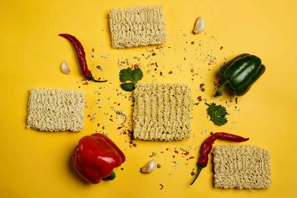 Four Dry Instant Noodles Blocks Vegetables Spices Vibrant Yellow Background — Stok Foto