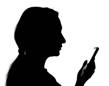 silhouette of a businesswoman using a smartphone