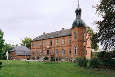 Authentic old German mansion with a tower serving as horse boarding stable now