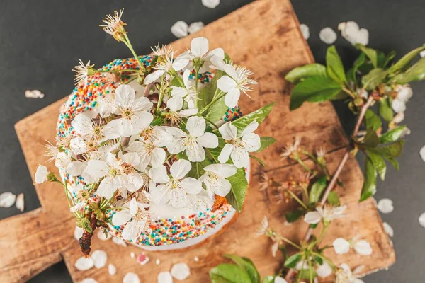 Top view of easter cake decorated with cherry flowers on wooden 
