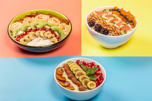 Variants of a healthy breakfast of oatmeal on the yellow, pink a