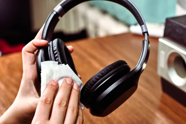 Cleaning headphones with wet wipes. Prevention of coronavirus in