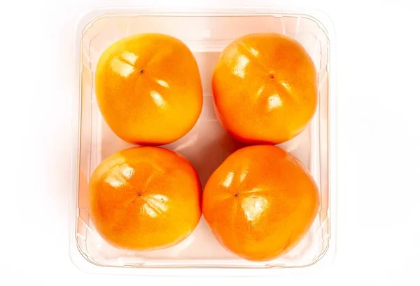 Top View Persimmon Fruits Plastic Container — Photo
