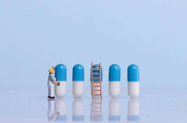 Miniature painter painting pills
