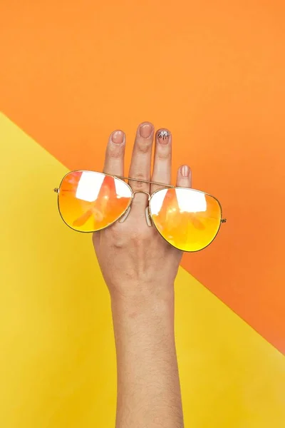 Woman Hand Holding Bright Sunglasses — Foto Stock